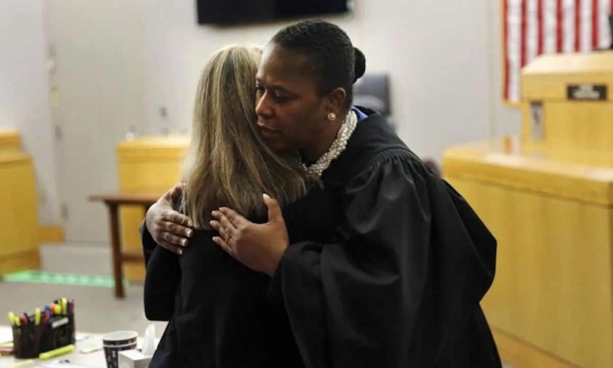 State District Judge Tammy Kemp gives former Dallas Police Officer Amber Guyger a hug before Guyger leaves for jail in Dallas on Oct. 2, 2019. (Tom Fox/The Dallas Morning News via AP, Pool)