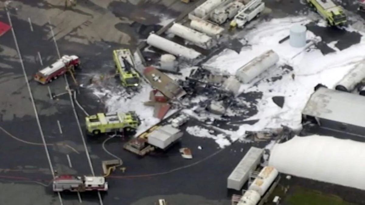 In this aerial image taken from video, emergency crews respond to where a World War II-era bomber B-17 plane crashed at Bradley International Airport in Windsor Locks, Conn., on Oct. 2, 2019. (WFXT Boston 25 News via AP)