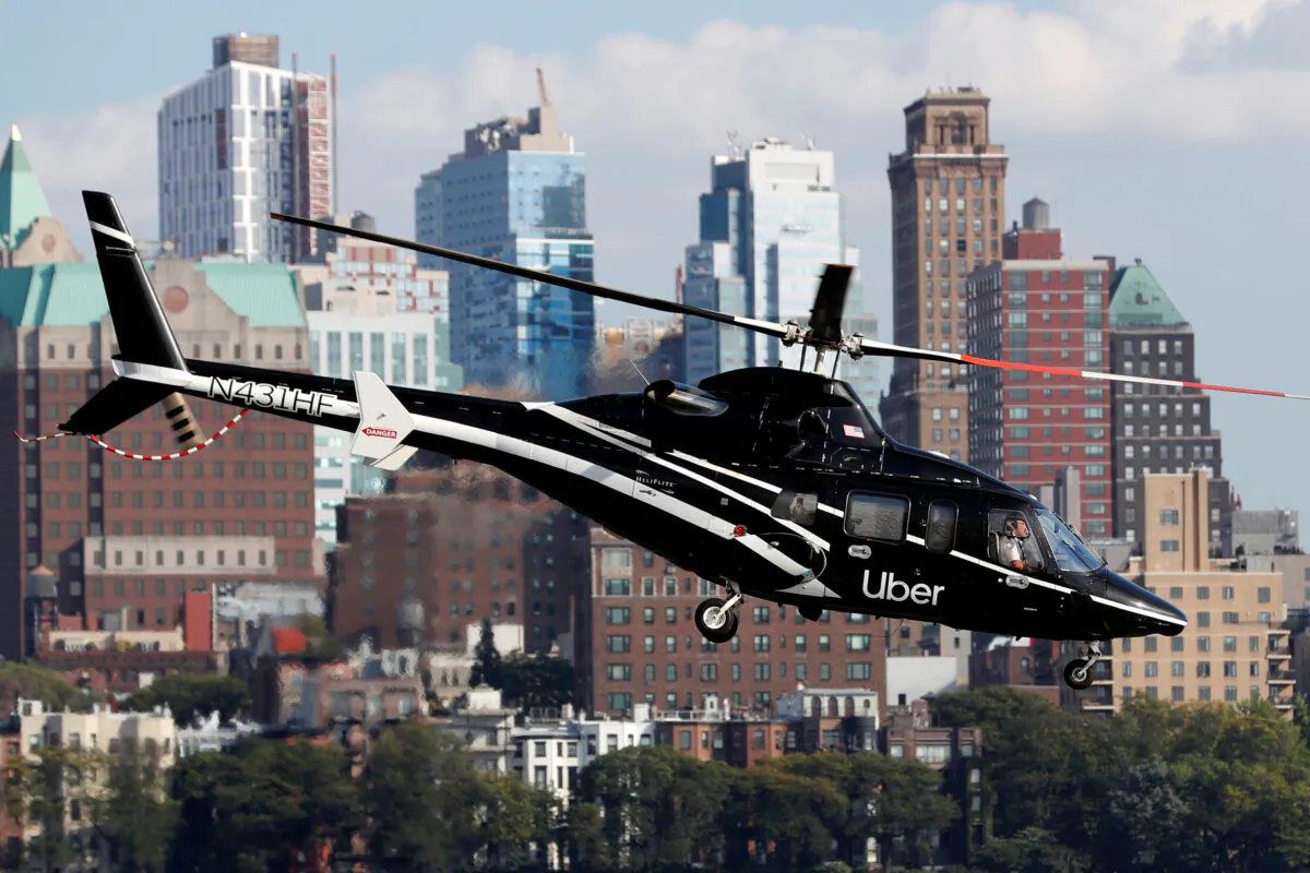 A helicopter operated by Uber Copter, a new service by the ride-sharing company Uber, providing service from Manhattan to New York's JFK International Airport initially for Diamond and Platinum Uber Rewards members as well as special Uber partners takes off from Manhattan, New York, U.S., Oct. 2, 2019. (Mike Segar/Reuters)