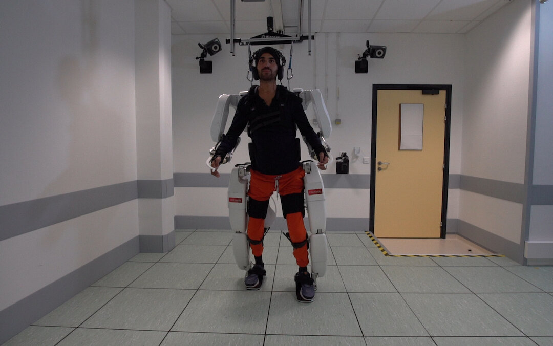 A patient with tetraplegia walks using an exoskeleton in Grenoble, France, in Feb. 2019. (Fonds De Dotation Clinatec/La Breche/Handout via Reuters)