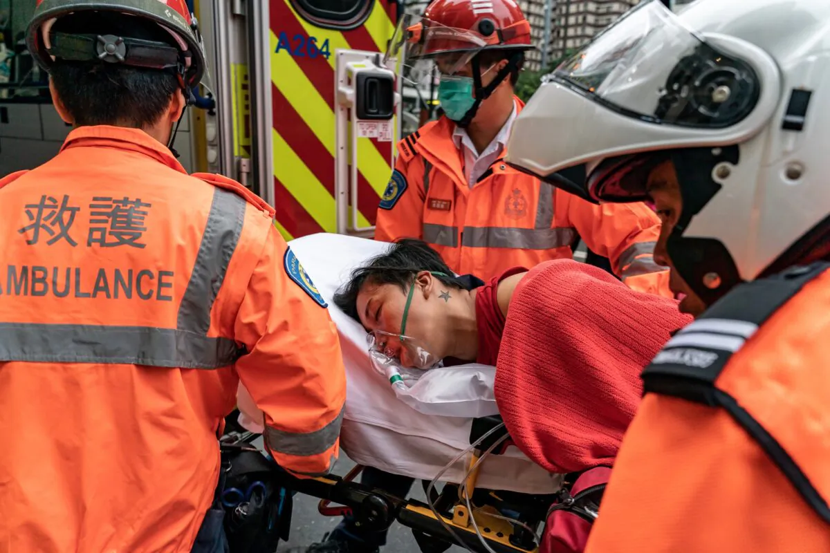 A pedestrian is lifted into an ambulance after inhaling tear gas in Wan Chai district in Hong Kong on October 6, 2019. (Anthony Kwan/Getty Images)