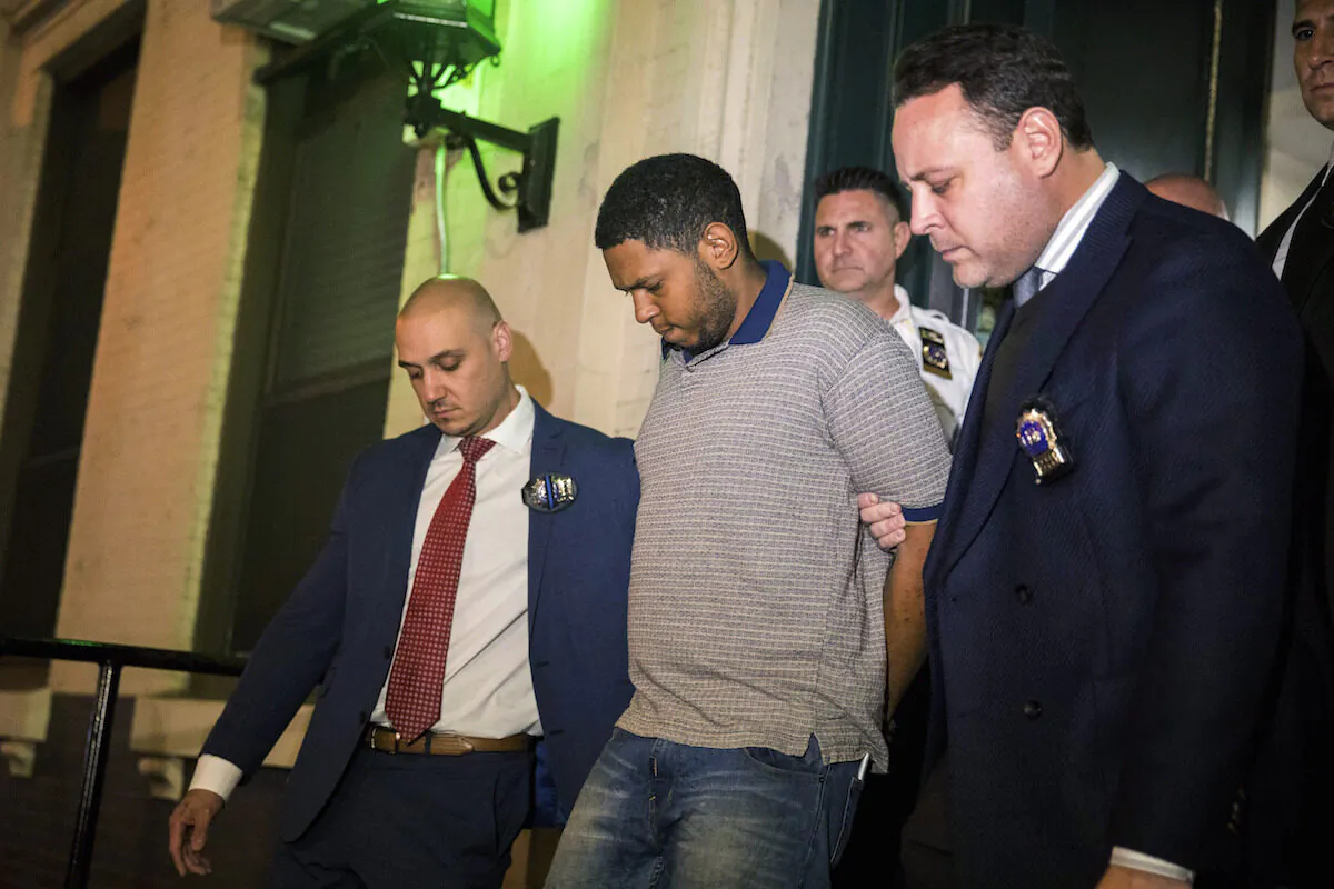 Police officers escort Randy Rodriguez Santos from the 5th Precinct to a vehicle bound for a hospital for evidence collection, in New York City on Oct. 5, 2019. (Julius Constantine Motal/AP Photo)