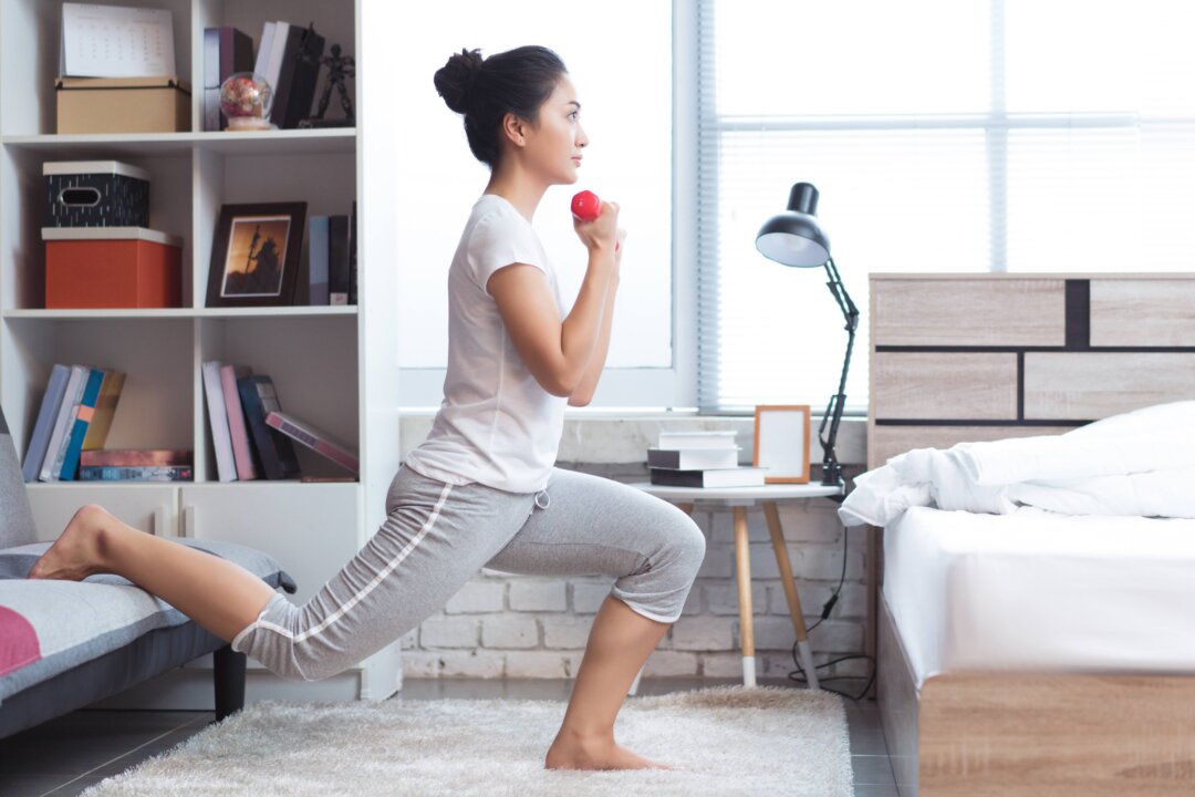 A bedside gym can be as simple as a yoga mat and a couple weights. (TORWAISTUDIO/Shutterstock)