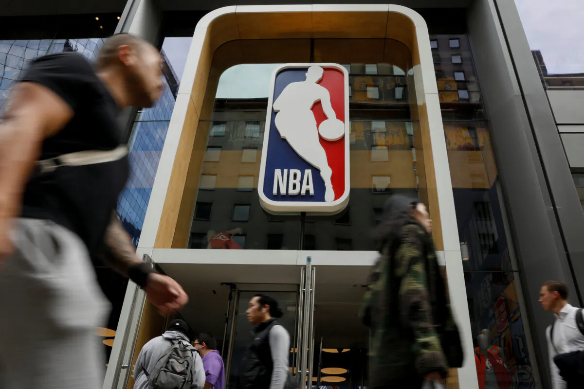 The NBA logo is displayed as people pass by the NBA Store in New York, N.Y., on Oct. 7, 2019. (Brendan McDermid/Reuters)