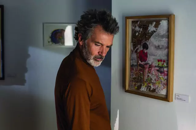 Antonia Banderas as a filmmaker, has a memory triggered by a picture of a body reading, in “Pain and Glory.” (Sony Pictures)