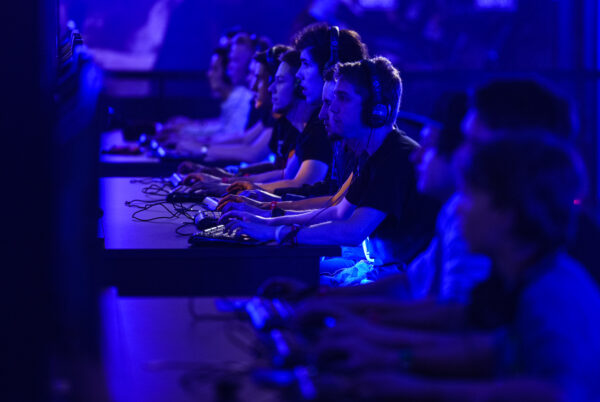 Visitors try out games at the Blizzard Entertainment stand at the Gamescom 2015 gaming trade fair in Cologne, Germany.