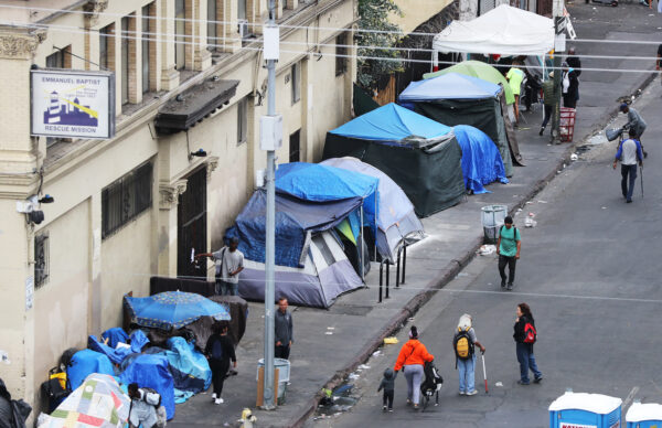 People walk in Skid Row in Los Angeles