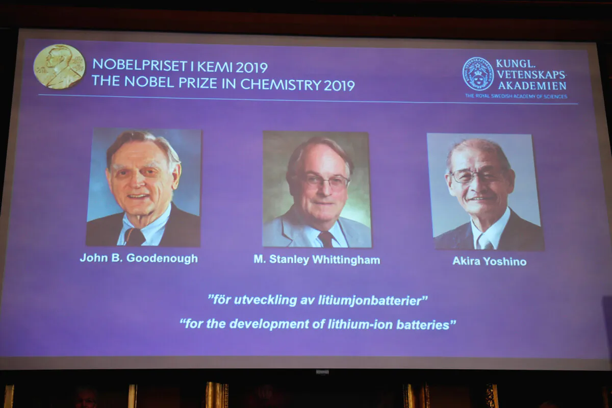 A screen displays the portraits of the laureates of the 2019 Nobel Prize in Chemistry (L-R) John B. Goodenough, M. Stanley Whittingham, and Akira Yoshino "for the development of lithium-ion batteries" during a news conference at the Royal Swedish Academy of Sciences in Stockholm, Sweden on Oct. 9, 2019. (Naina Helen Jama/TT News Agency/via Reuters)