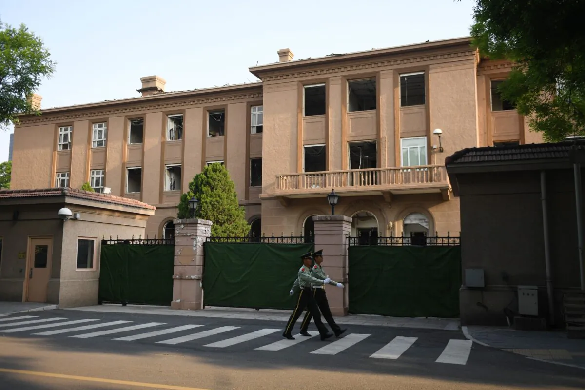 Chinese paramilitary police officers march past the former U.S. embassy in Beijing on May 10, 2019. (Greg Baker/AFP/Getty Images)