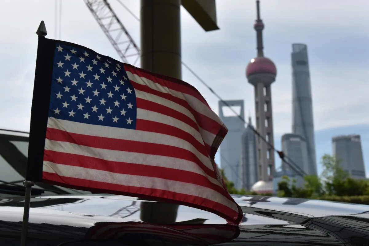 A U.S. flag flies on a U.S. consulate car with the backdrop of buildings in the Lujiazui financial district, in Shanghai on July 31, 2019. (Greg Baker/AFP/Getty Images)