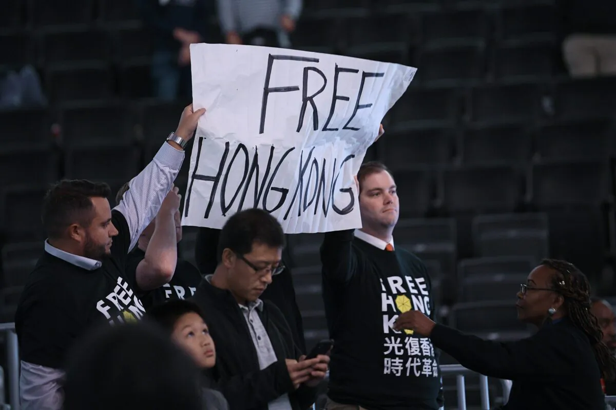 Activists hold up a sign before an NBA exhibition basketball game between the Washington Wizards and the Guangzhou Loong-Lions in Washington on Oct. 9, 2019. (Nick Wass/AP Photo)