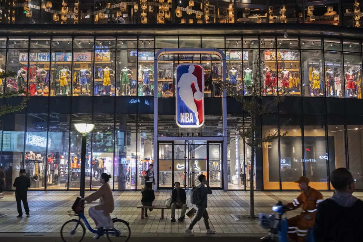 People walk by and sit outside the NBA flagship retail store in Beijing, China on Oct. 9, 2019. (Kevin Frayer/Getty Images)