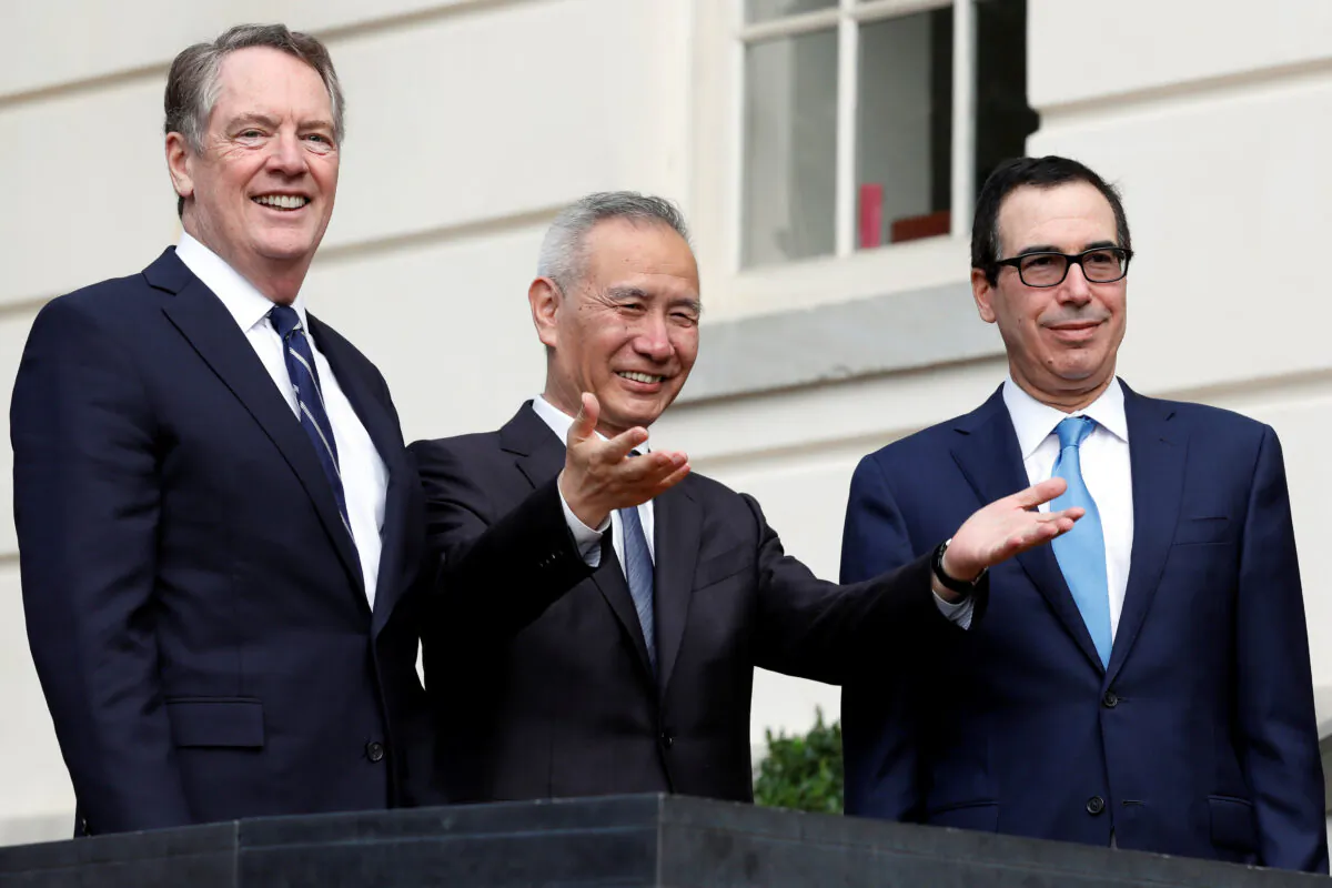 China's Vice Premier Liu He gestures to the media between U.S. Trade Representative Robert Lighthizer (L) and Treasury Secretary Steve Mnuchin before the two countries' trade negotiations in Washington, D.C., on Oct. 10, 2019. (Yuri Gripas/Reuters)