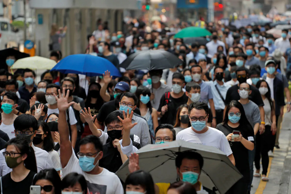 People march to protest against what they say is the abuse of pro-democracy protesters by Hong Kong police, at Chater Garden in Central district, Hong Kong, China on Oct. 11, 2019. (Susana Vera/Reuters)