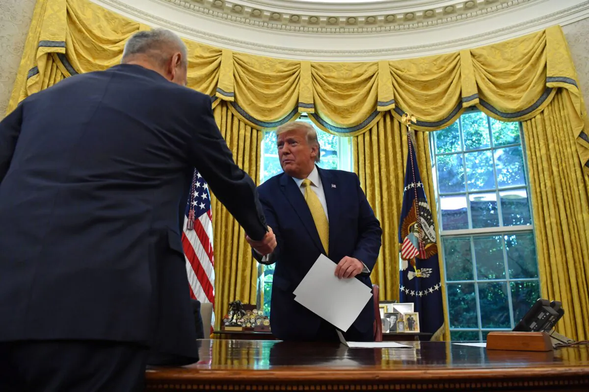 Chinese Vice Premier Liu He (L) hands over a letter of Chinese leader Xi Jinping to President Donald Trump at the Oval Office of the White House in Washington, on Oct. 11, 2019 (NICHOLAS KAMM/AFP via Getty Images)