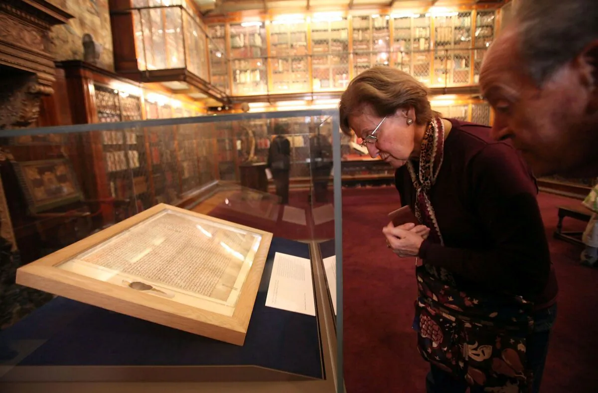 Visitors look at one of the earliest original manuscripts of the Magna Carta from 1217 at the Morgan Library & Museum on April 21, 2010, in New York City. (Mario Tama/Getty Images)