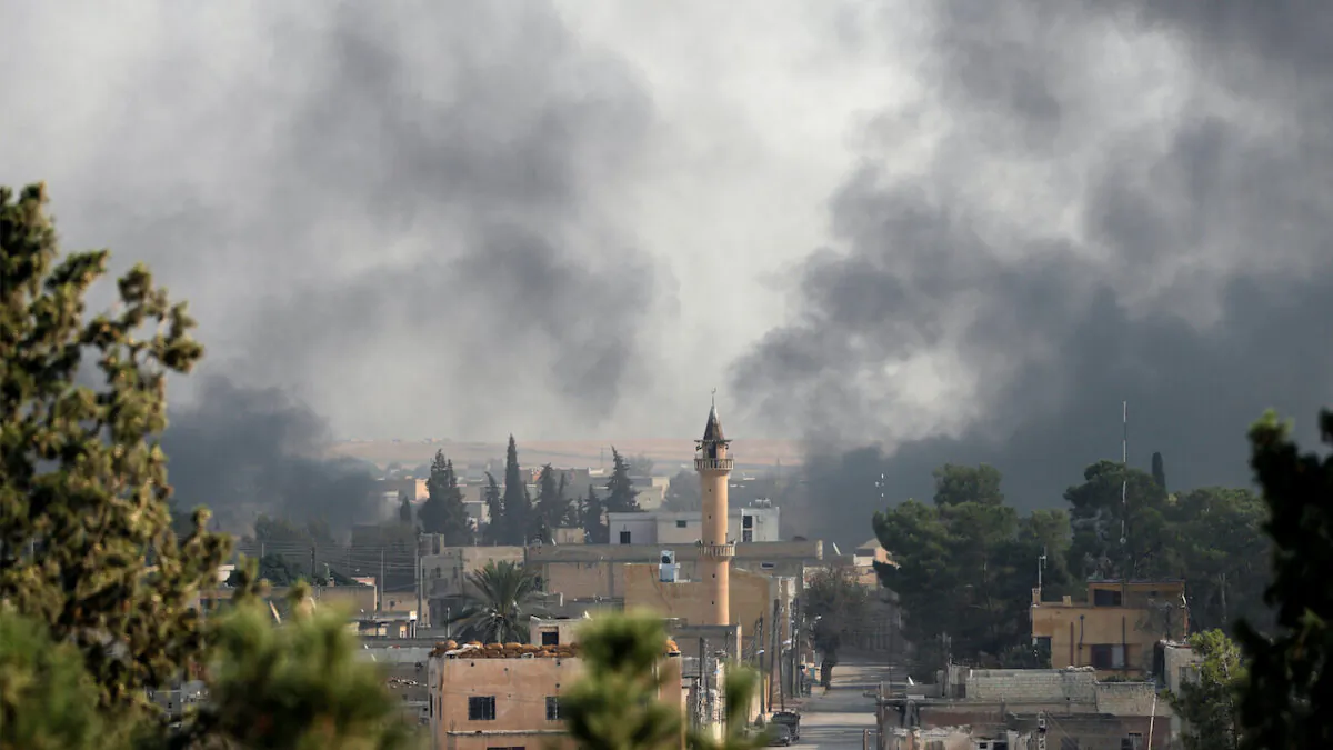 Smoke rises over the Syrian town of Tel Abyad, as seen from the Turkish border town of Akcakale in Sanliurfa province, Turkey, on Oct. 10, 2019. (Murad Sezer/Reuters)