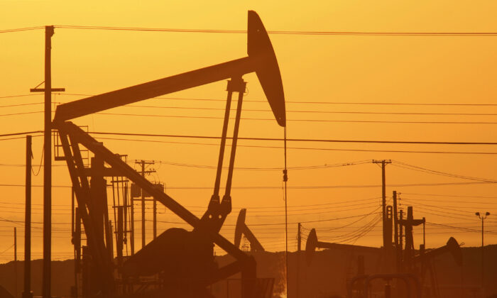 Pump jacks are seen at dawn near Lost Hills, California on March 24, 2014. (David McNew/Getty Images)