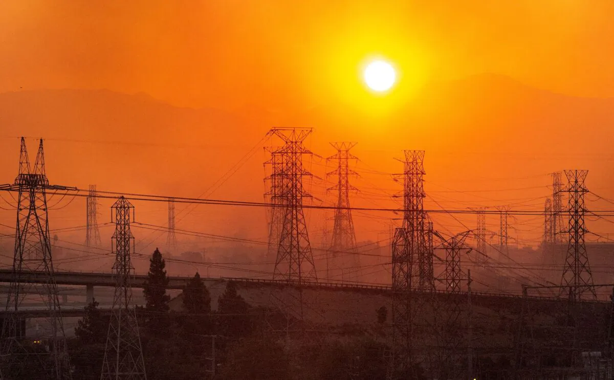 The sun rises over power lines along a smokey horizon during the Saddleridge Fire in Newhall, Calif., on Oct. 11, 2019. (Josh Edelson/AFP via Getty Images)
