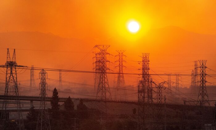 The sun rises over power lines along a smokey horizon during the Saddleridge Fire in Newhall, California on Oct. 11, 2019. (Josh Edelson/AFP via Getty Images)