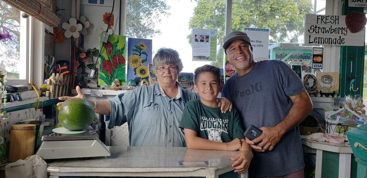 Meridyth Sealey (L), with Lo'ihi Pokini and his father Mark Pokini in their kitchen at Kula Country Farms in Kula, Hawaii. On Oct. 11, 2019. (Juliane Pokini via AP)