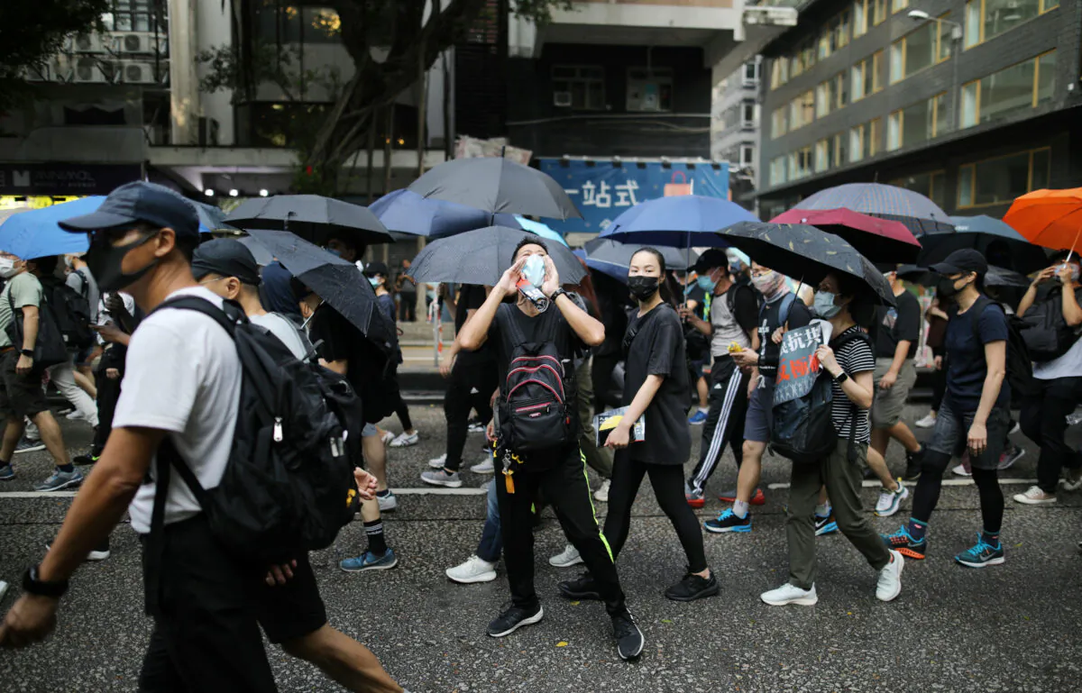 Anti-government demonstrators march in protest against the invocation of the emergency laws in Hong Kong, China, Oct. 12, 2019. (Reuters/Ammar Awad)
