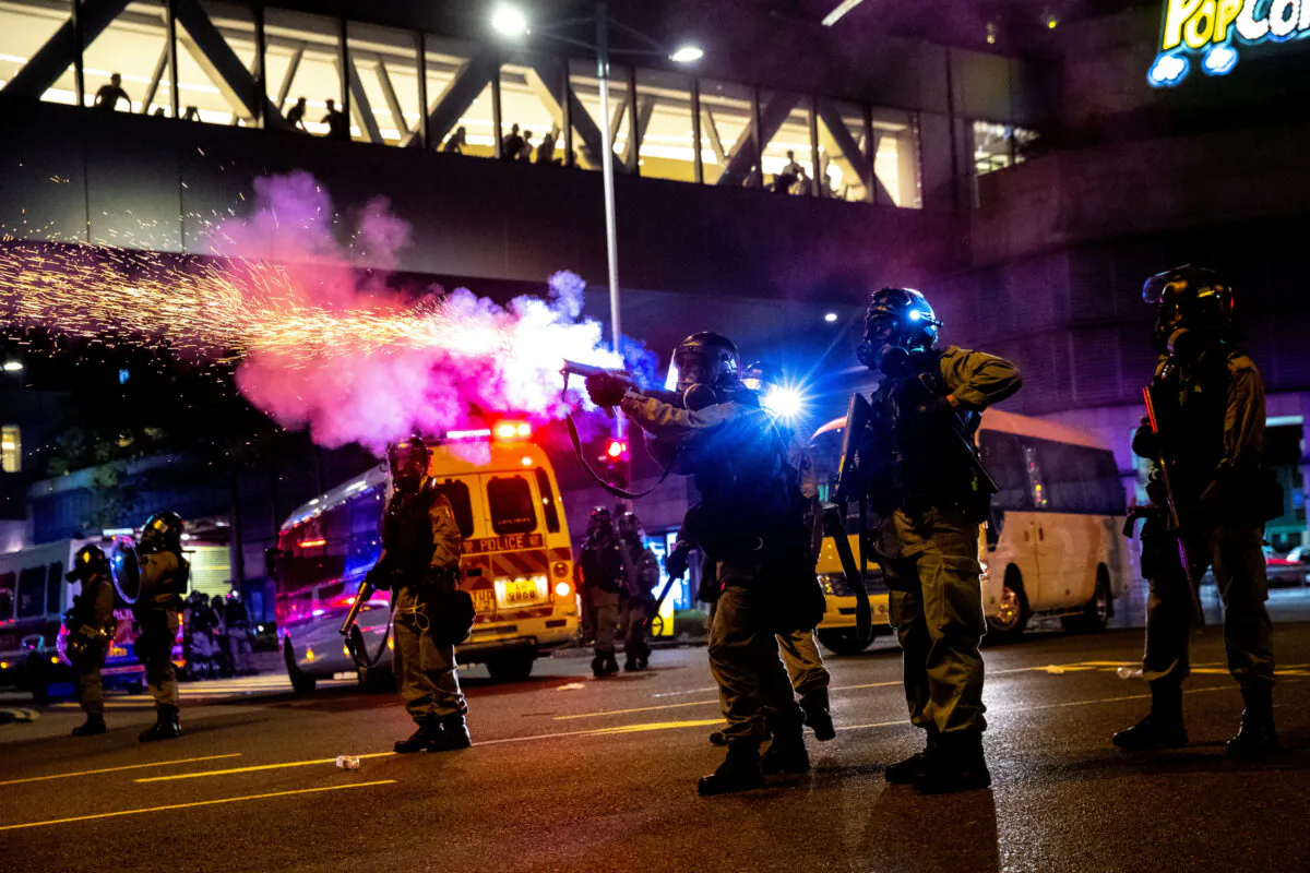 A riot police officer fires a tear gas canister toward anti-government protesters during a demonstration in the Tseung Kwan O residential area in Kowloon, Hong Kong, China, Oct. 7, 2019. (Reuters/Athit Perawongmetha/File Photo)