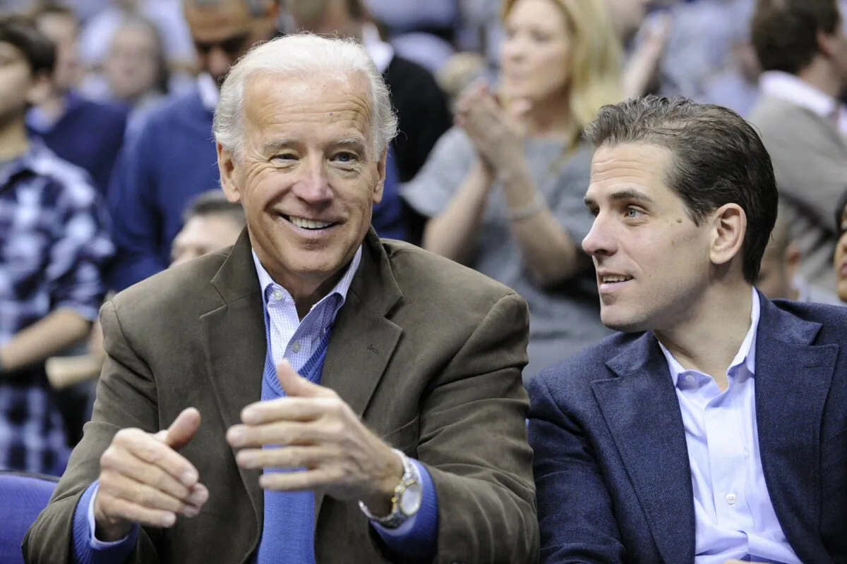 Then-Vice President Joe Biden, left, with his son Hunter at the Duke Georgetown NCAA college basketball game in Washington on Jan. 30, 2010. (Nick Wass/AP Photo)