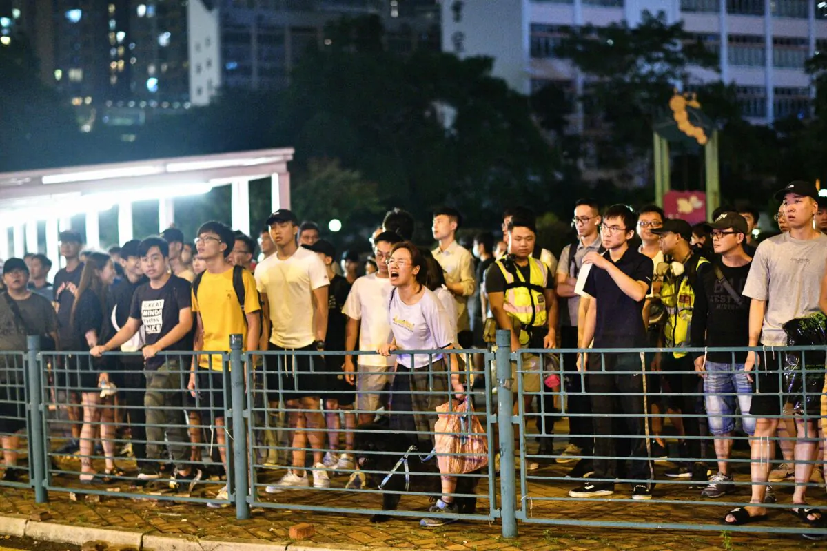 Residents shout at Hong Kong police after they detained a man during protests in the Tseung Kwan O area of Kowloon in Hong Kong on October 13, 2019. (ANTHONY WALLACE/AFP via Getty Images)