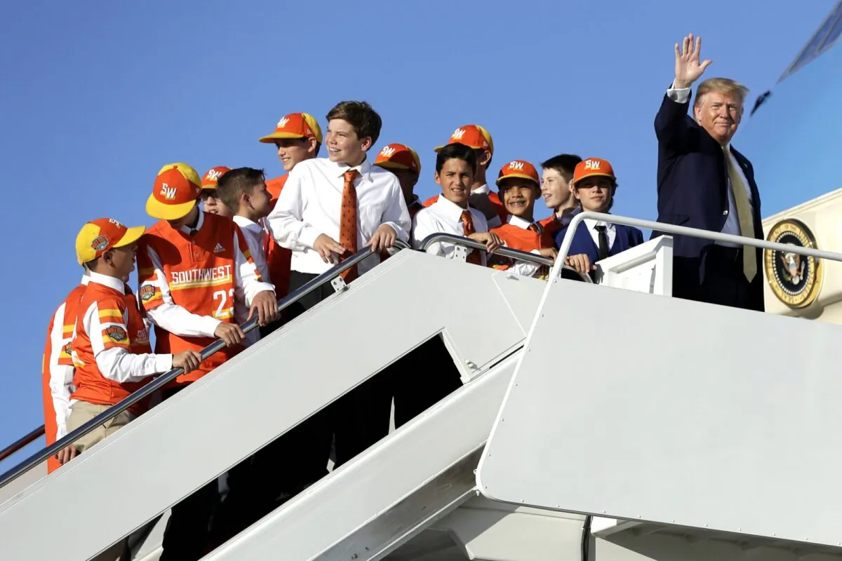 President Donald Trump walks to board Air Force One with Louisiana's Eastbank Little League team who won the 2019 Little League Baseball World Series, in Andrews Air Force Base, Md., on Oct. 11, 2019. (Evan Vucci/AP Photo)