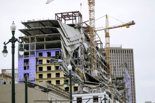 Debris hangs on the side of the building