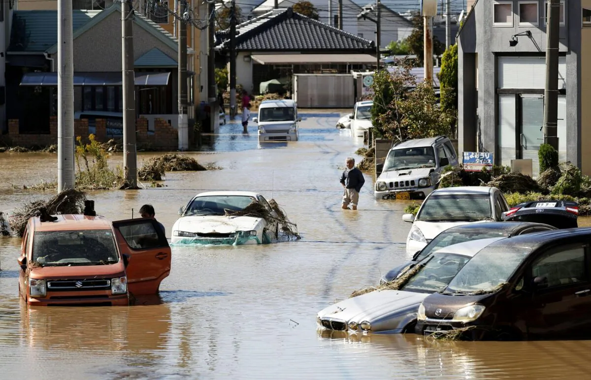 Vehicles are seen in mud water as Typhoon Hagibis hit the city in Sano, Tochigi prefecture, on Oct. 13, 2019. (Kyodo News via AP)