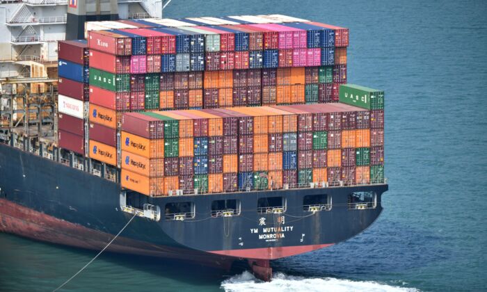 A cargo ship loaded with containers is pictured near the port in Hong Kong on October 5, 2019. (ANTHONY WALLACE/AFP via Getty Images)