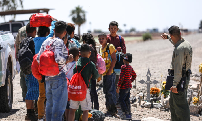 A group of illegal aliens is processed by Border Patrol agents after crossing from Mexico into Yuma, Ariz., on April 13, 2019. (Charlotte Cuthbertson/The Epoch Times)