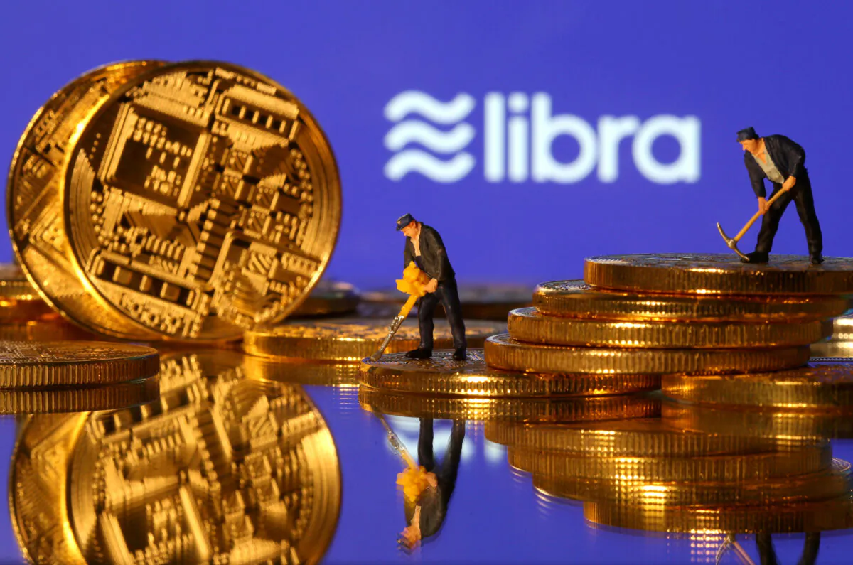 Small toy figures are seen on representations of virtual currency in front of the Libra logo in this illustration picture, June 21, 2019. (Dado Ruvic/File Photo)