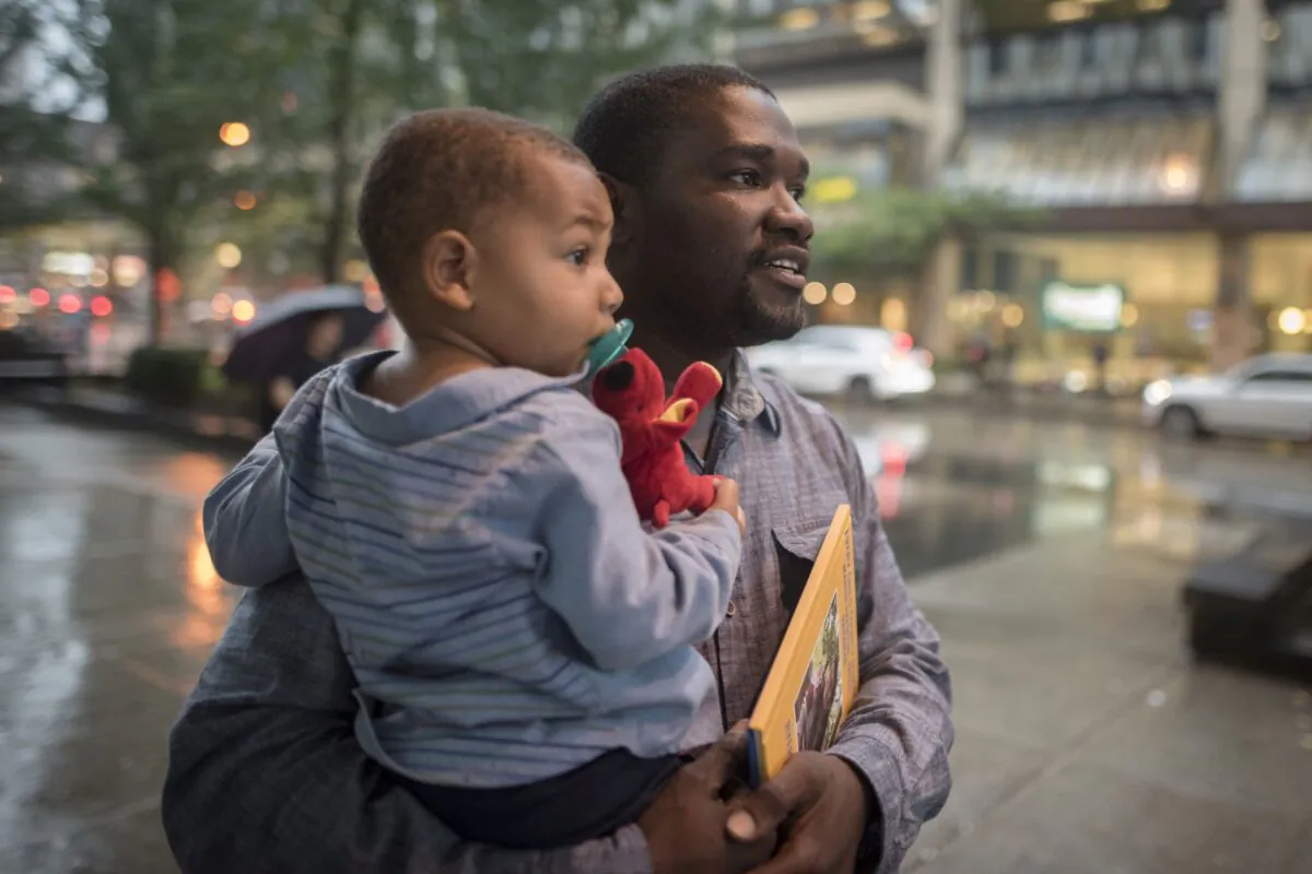 Cialin Dany holds his son Evan, after attending a memorial service for his wife Alishia Liolli, who died in hurricane Dorian in the Bahamas, in Toronto on Oct. 1, 2019. (THE CANADIAN PRESS/ Tijana Martin)