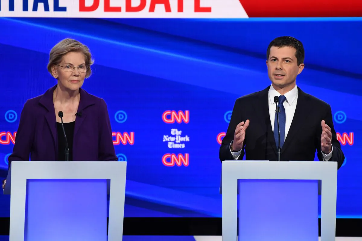 South Bend, Indiana Mayor Pete Buttigieg, right, speaks as Sen. Elizabeth Warren (D-Mass.) looks on during the Democratic Presidential Debate at Otterbein University in Westerville, Ohio on Oct. 15, 2019. (Photo by Win McNamee/Getty Images)