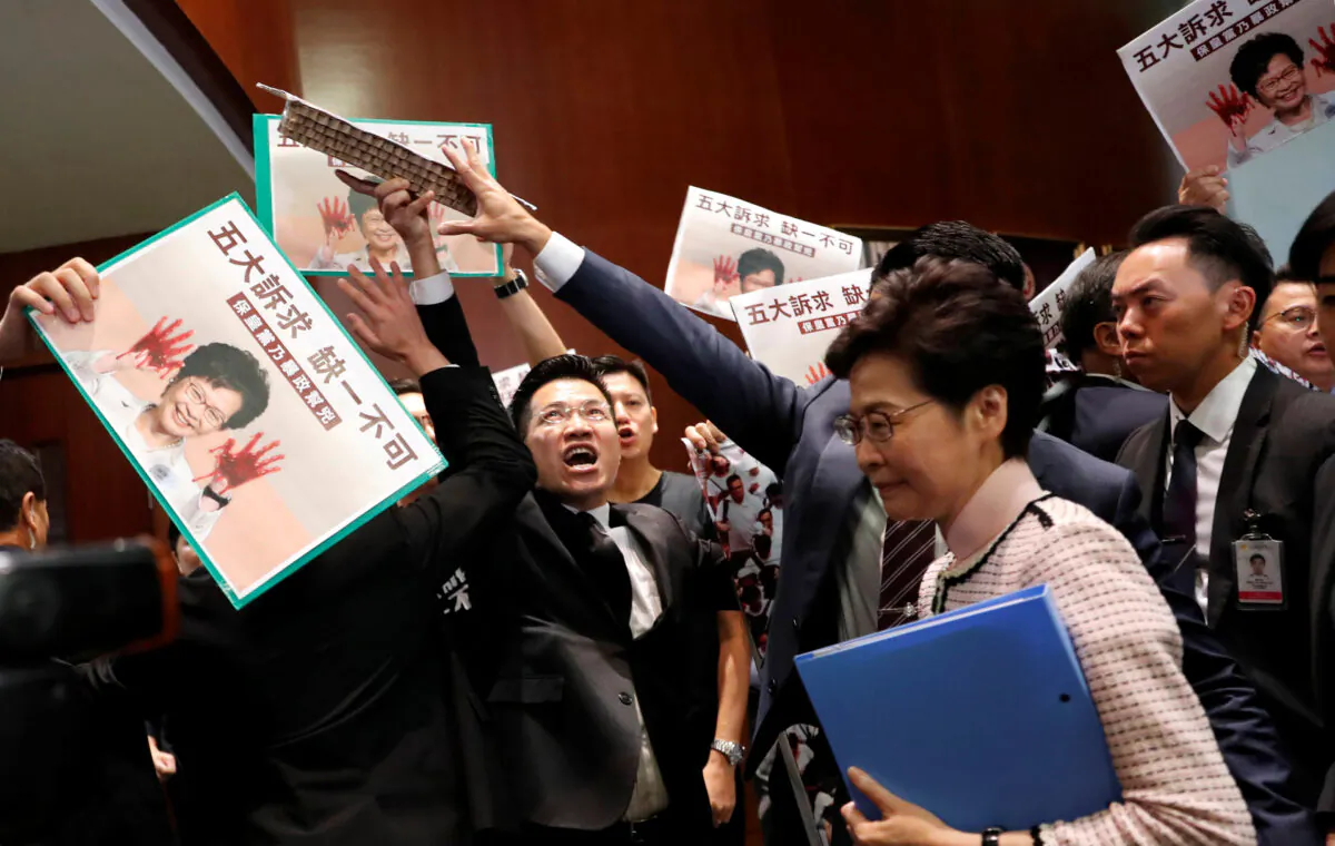 Hong Kong Chief Executive Carrie Lam arrives to deliver her annual policy address, as lawmakers shout protests, at the Legislative Council in Hong Kong, China, on Oct. 16, 2019. (Tyrone Siu/Reuters)