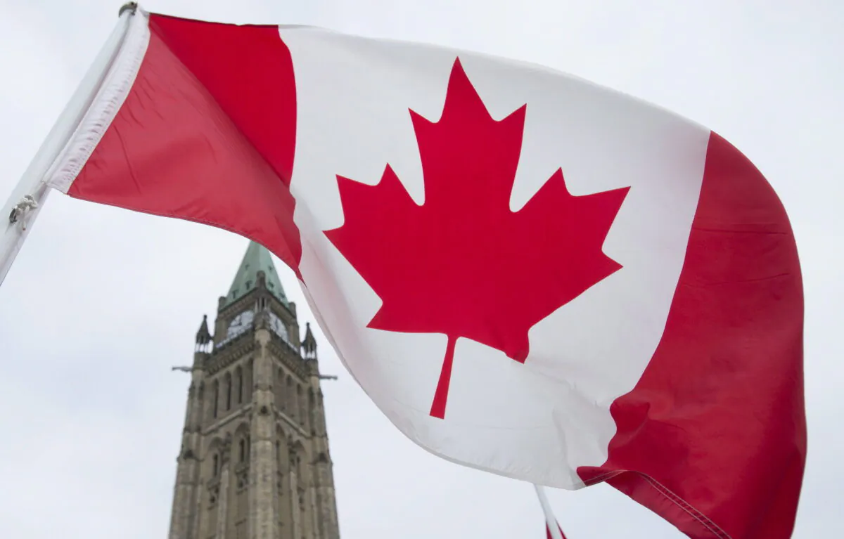 The Canadian flag flies on Parliament Hill in Ottawa in a file photo. (THE CANADIAN PRESS/Adrian Wyld)