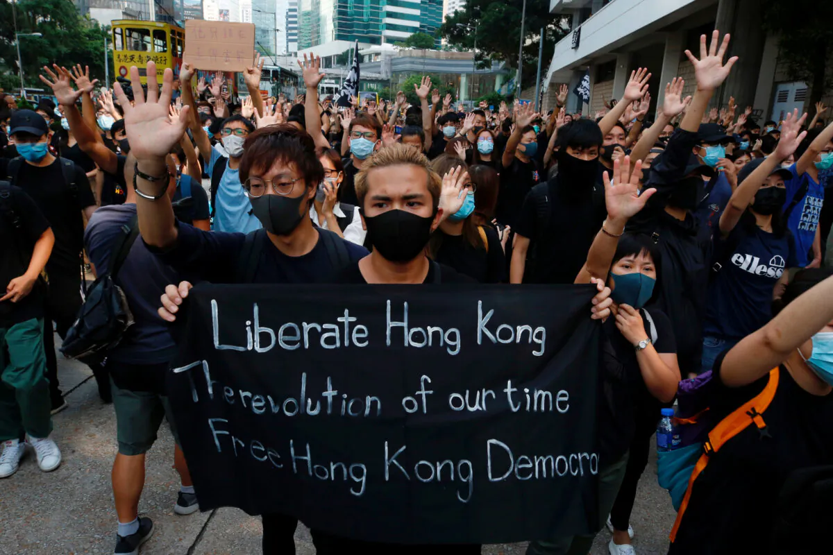 Hong Kong activists gather outside the High Court in Hong Kong, on Oct. 9, 2019. (Tyrone Siu/Reuters)