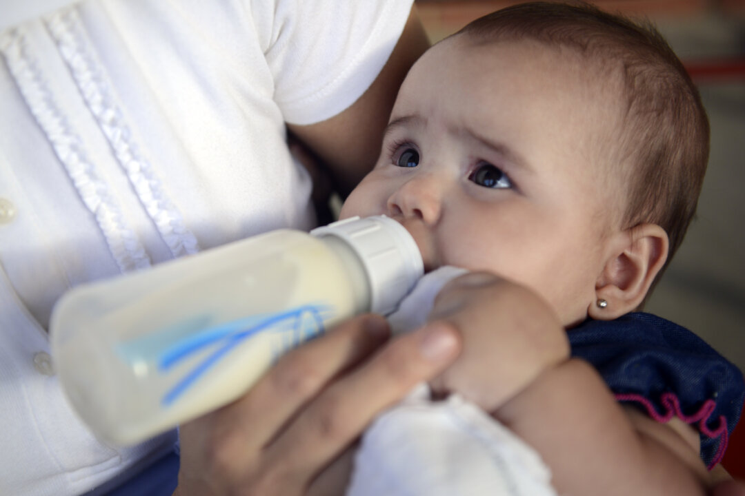A woman feeds her baby in a file photograph. (Leo Ramirez/AFP/Getty Images)