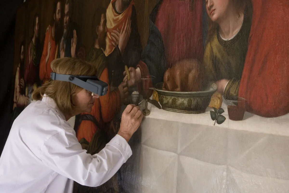 Conservator Rossella Lari makes a few finishing touches to Sister Plautilla Nelli's "Last Supper." (Rabatti & Domingie)
