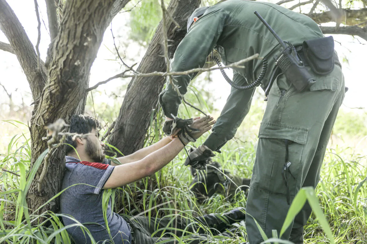 A Border Patrol agent take an illegal alien into custody near McAllen, Texas, on April 18, 2019. (Charlotte Cuthbertson/The Epoch Times)