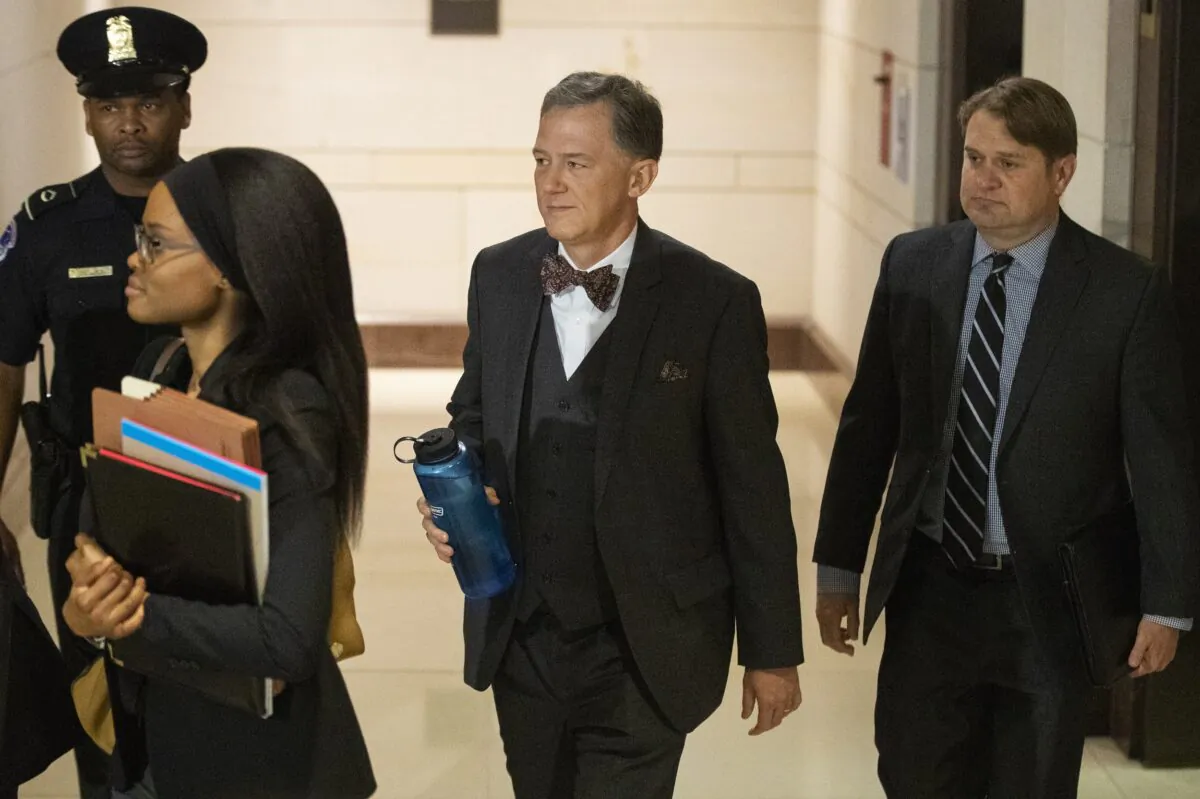 Deputy Assistant Secretary of State George Kent, second from right, arrives to appear before a joint House Committee on Foreign Affairs, Permanent Select Committee on Intelligence, and Committee on Oversight and Reform for a deposition on Capitol Hill in Washington on Oct. 15, 2019. (AP Photo/Manuel Balce Ceneta)