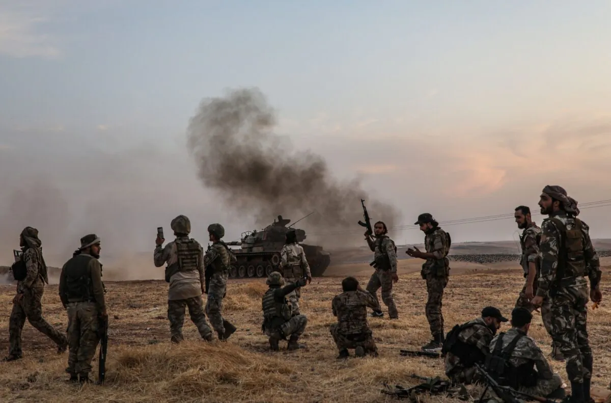 Turkish soldiers and Turkey-backed Syrian fighters gather on the northern outskirts of the Syrian city of Manbij near the Turkish border on October 14, 2019. (Zein Al Rifai/AFP via Getty Images)