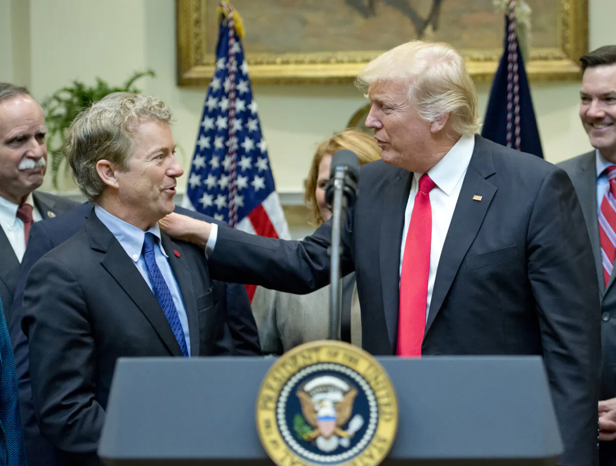 President Trump acknowledges Sen. Rand Paul (R-Ky.) prior to signing H.J. Res. 38, disapproving the rule submitted by the Department of the Interior known as the Stream Protection Rule in the Roosevelt Room of the White House in Washington on Feb. 16, 2017. (Ron Sachs-Pool/Getty Images)