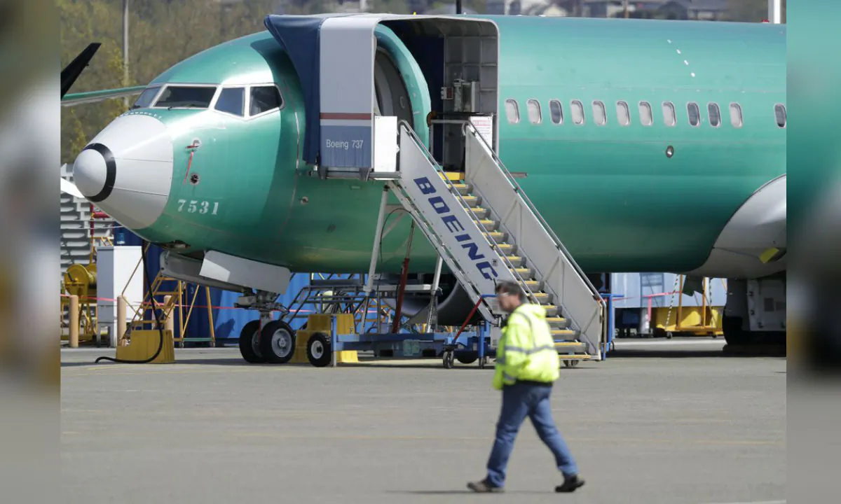 A worker walks past a Boeing 737 MAX 8 airplane being built for Oman Air at Boeing's assembly facility in Renton, Washington on April 26, 2019. (Ted S. Warren/AP Photo, File)