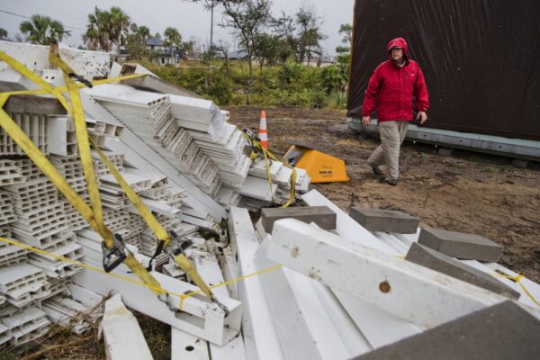 Chris Anderson ties down building materials