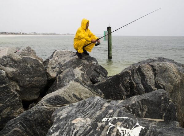 Michael Foster fishes as Tropical Storm Nestor approaches,