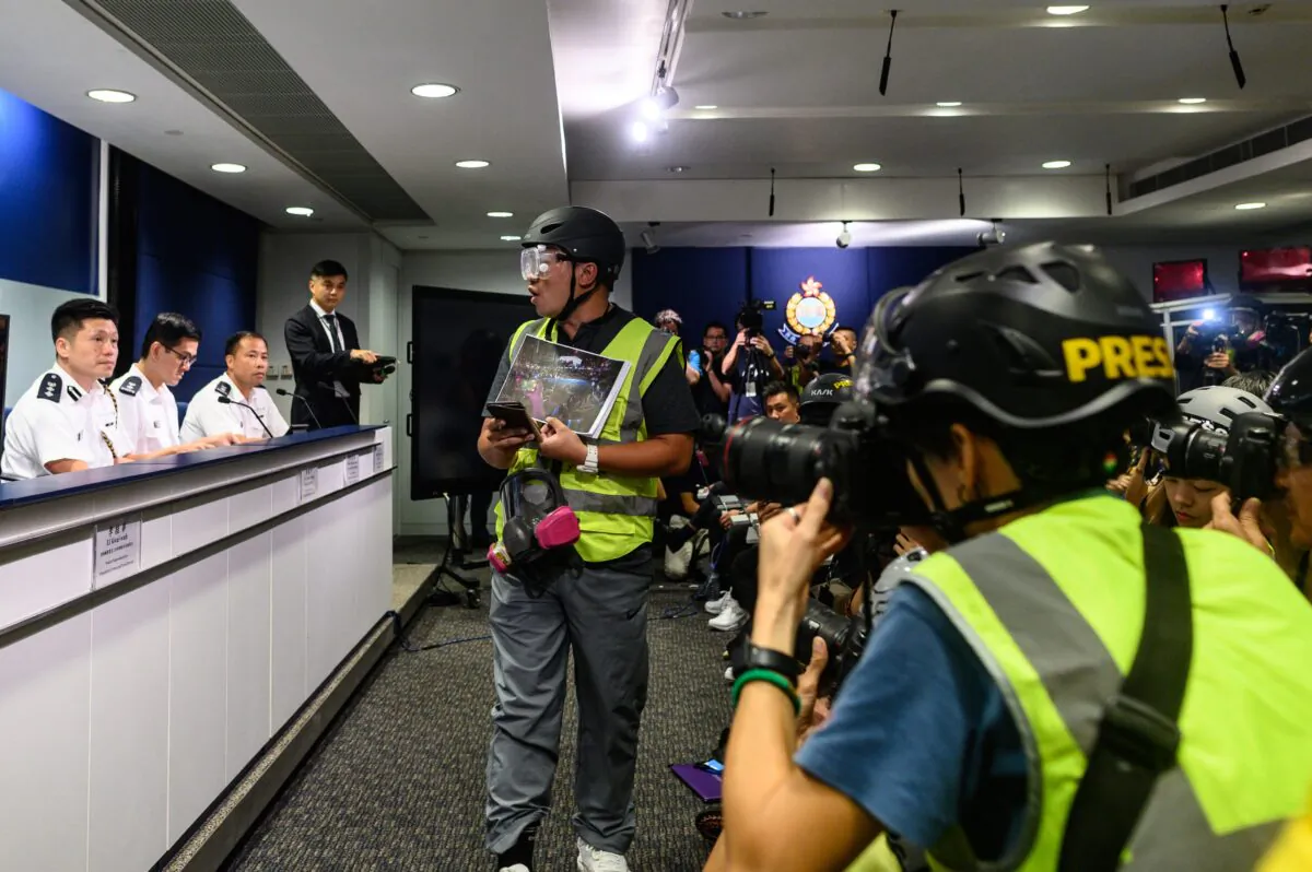 Journalists wear protective gear and high visibility vests at a press conference at police headquarters in Hong Kong on Sept. 9, 2019. (Philip Fong/AFP/Getty Images)